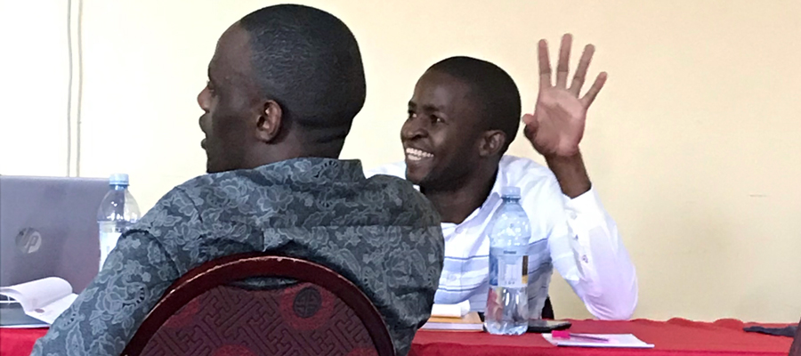 participants smiling in Uganda at the opening workshop